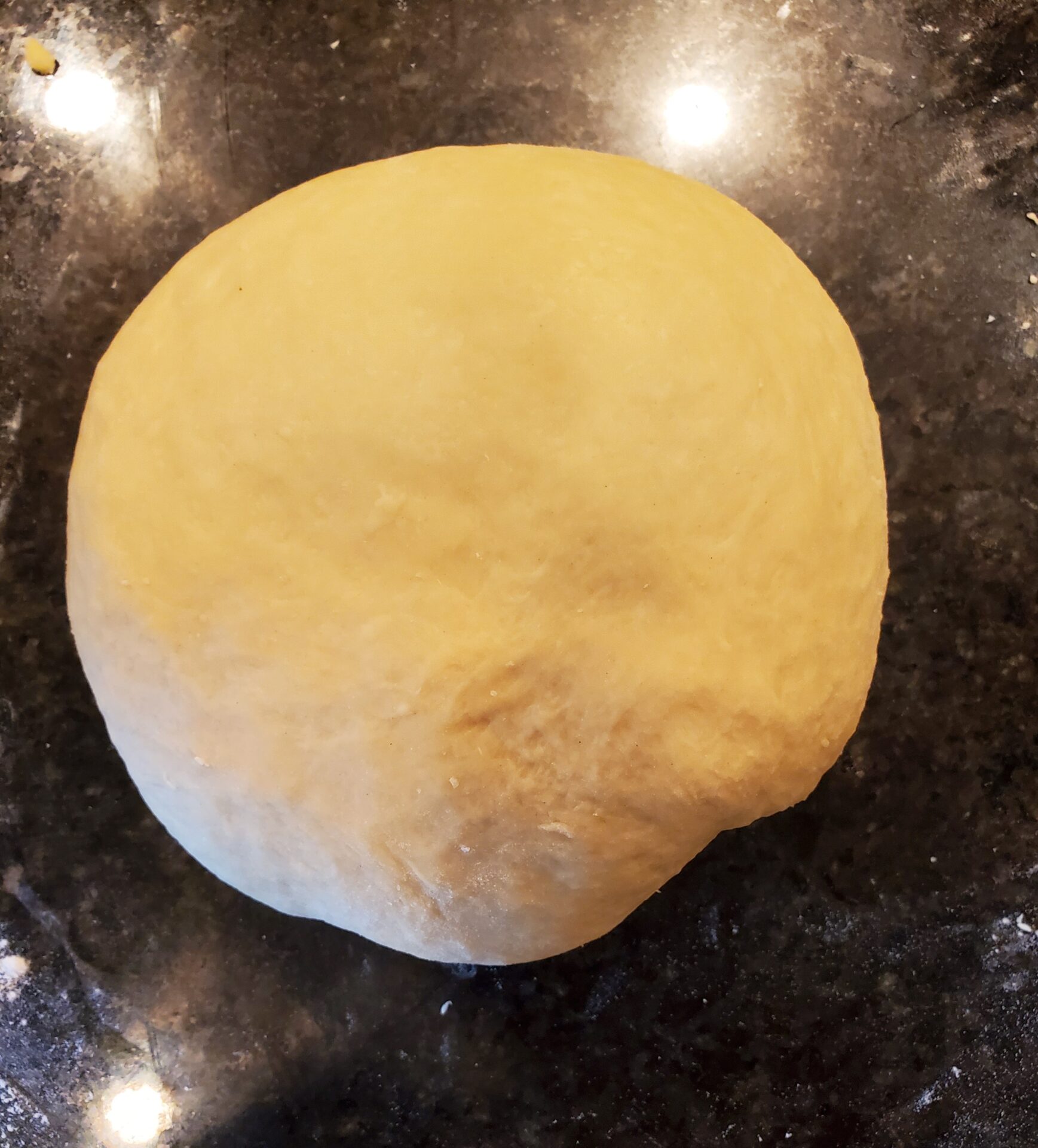 A dough is sitting on the counter ready to be put into the oven.