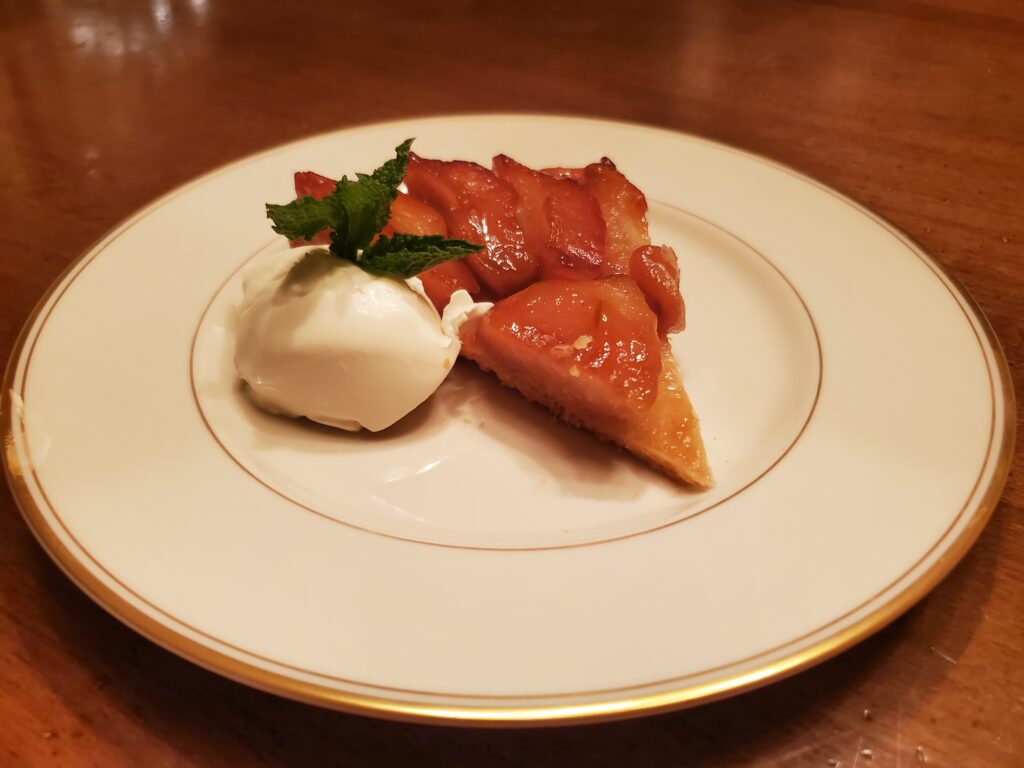 A white plate topped with a piece of cake and ice cream.