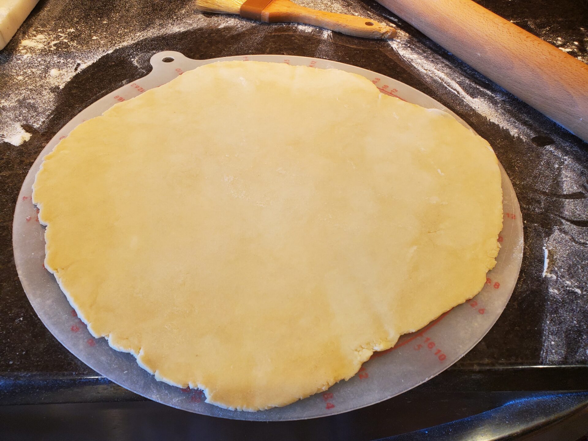 A pizza crust sitting on top of a pan.