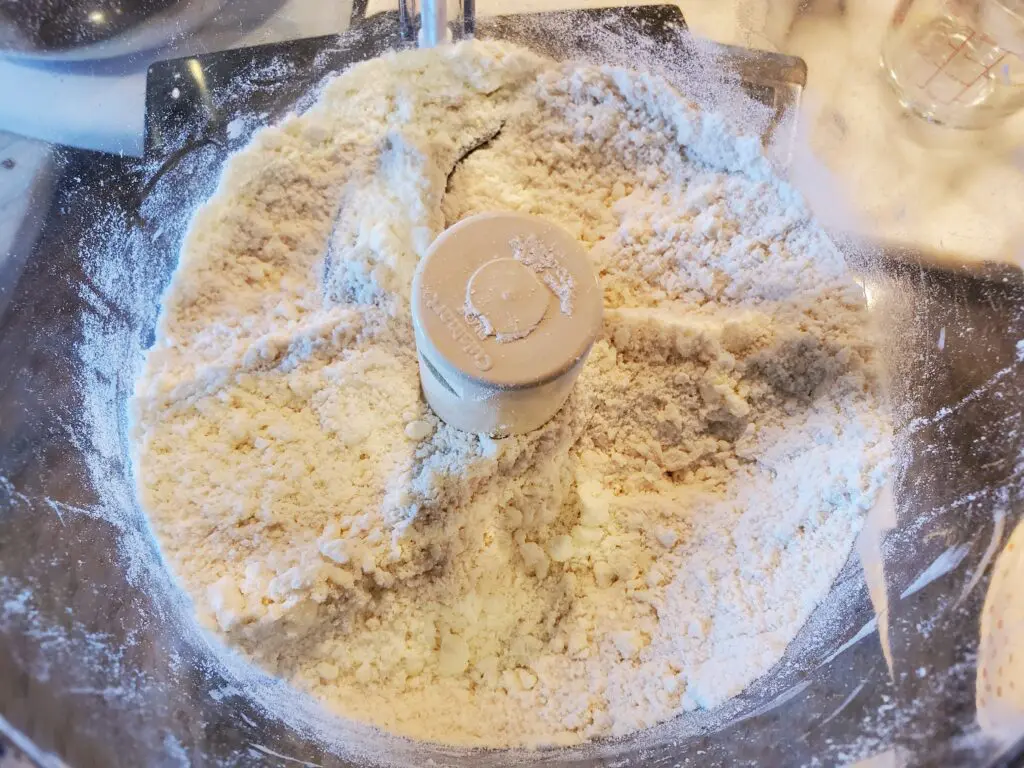 A food processor with some flour on it