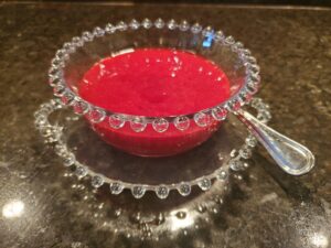 A bowl and plate with a spoon on it