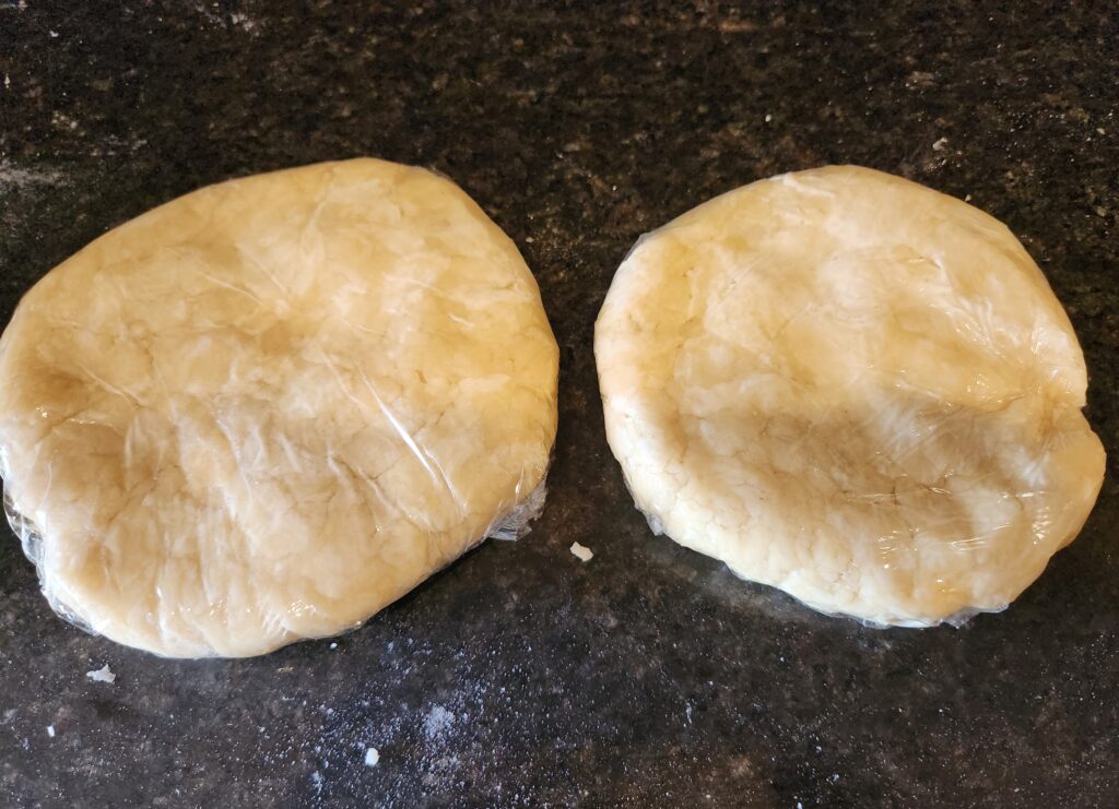 Two dough balls on a counter top.