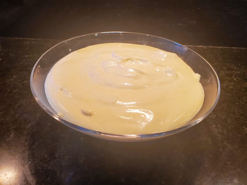 A glass bowl filled with creamy batter or custard.