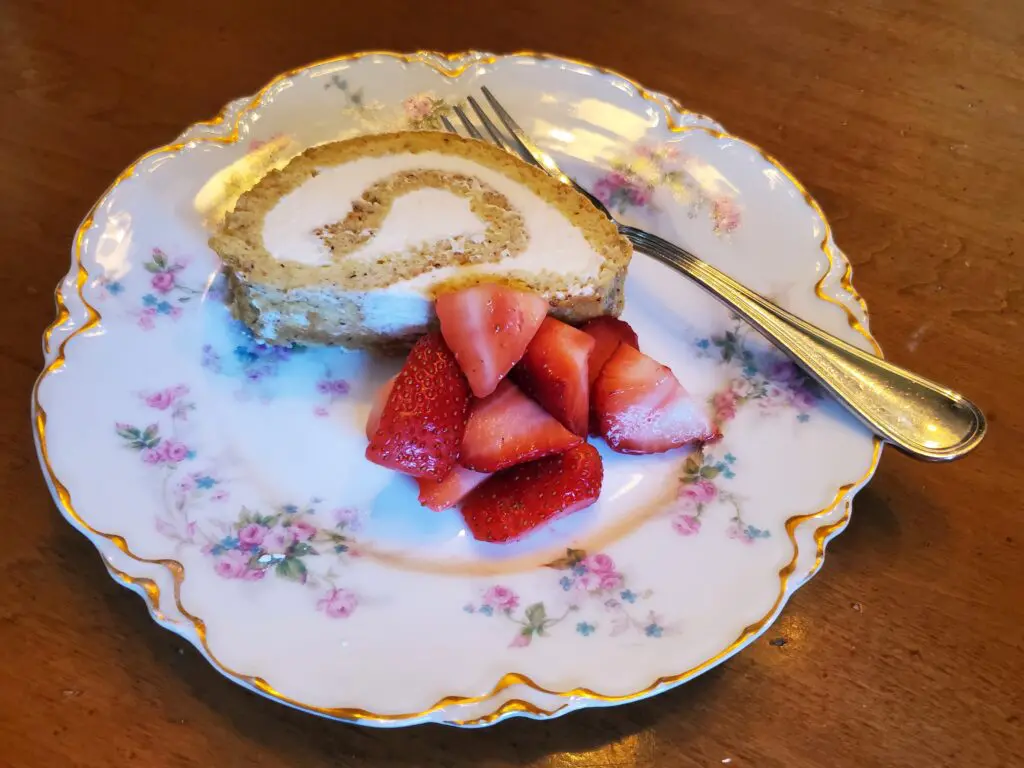 A plate with some strawberries and a piece of cake