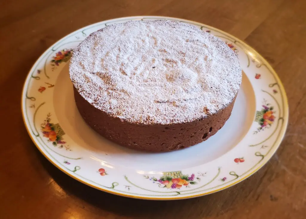 A cake on a plate sitting on top of a table.