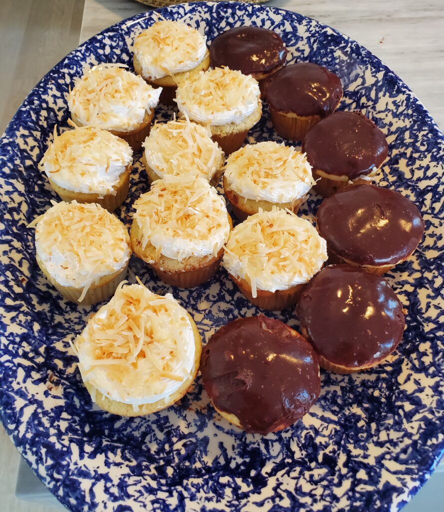 A plate of chocolate cupcakes on top of a table.