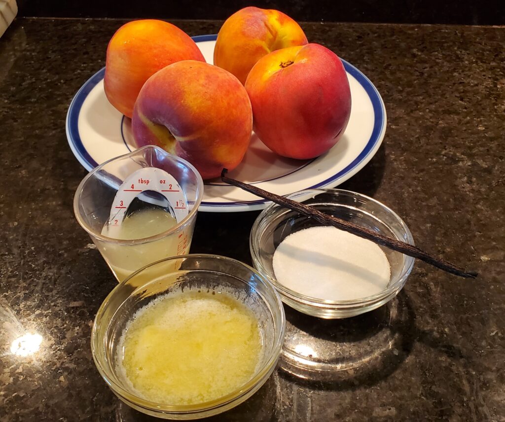 A bowl of peaches and two bowls with yogurt.