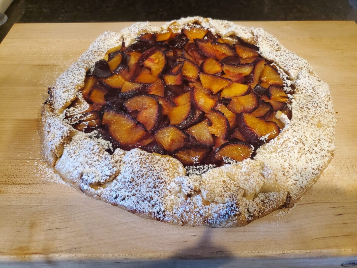 A pie with some type of fruit on top