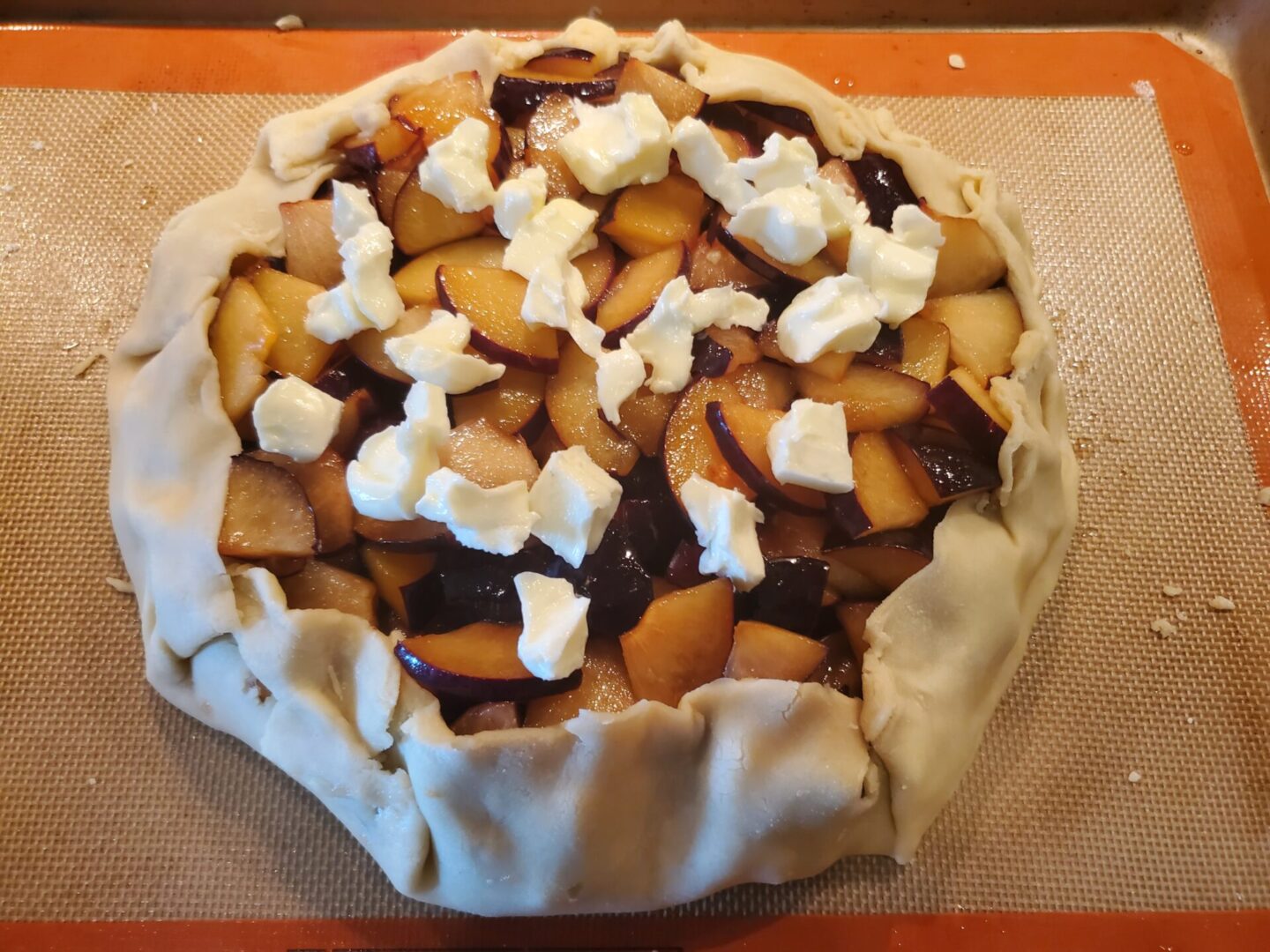 A pie with apples and whipped cream on top.