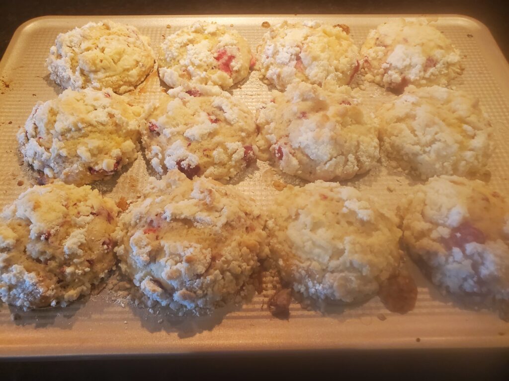 A wooden cutting board with some biscuits on it