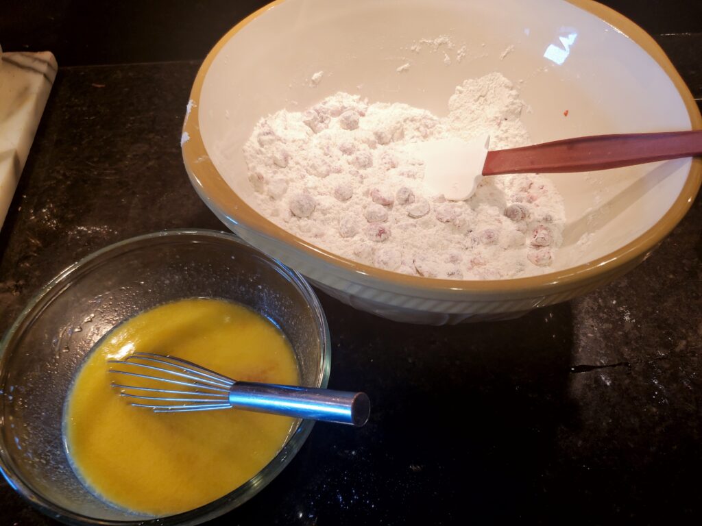 A bowl of cereal and a whisk in a glass.