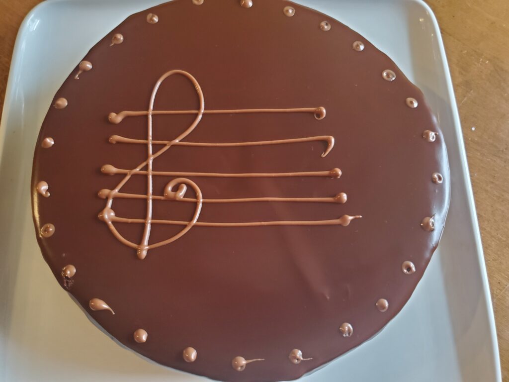 A chocolate cake with music notes on top of it.