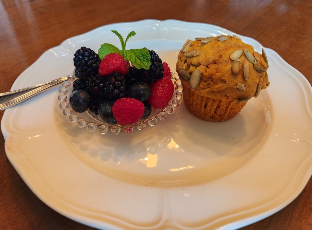 A muffin and berry on a plate