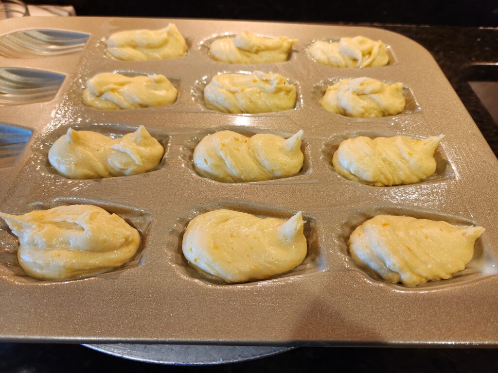 A tray of pastries are being made.