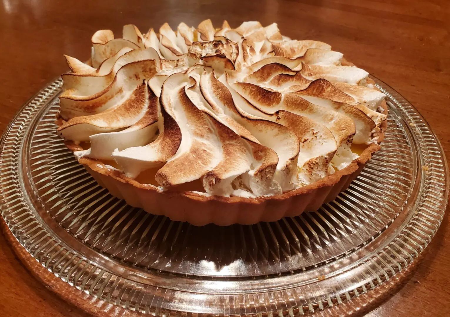 A meringue pie on a glass plate, featured in The Friday Baking Project blog.