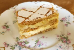 A piece of cake on a plate with flowers.