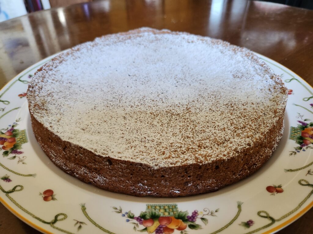 carrot pecan cake on plate with powdered sugar