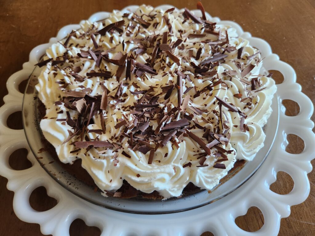 A white plate with a cake on it.