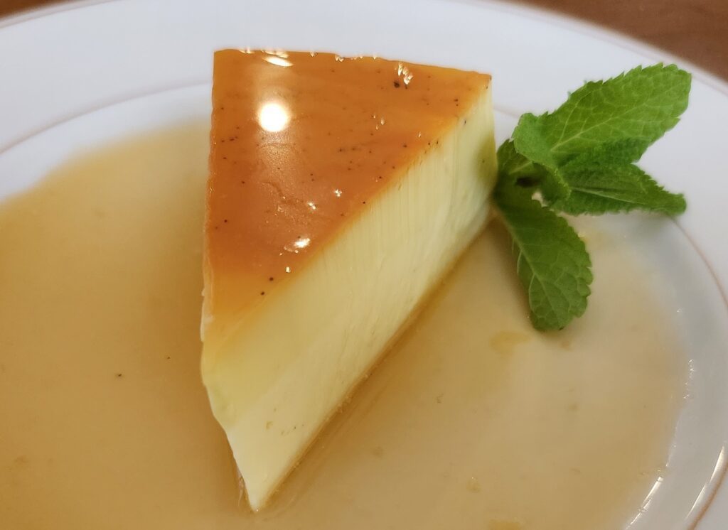 A piece of cheesecake sitting on top of a white plate.