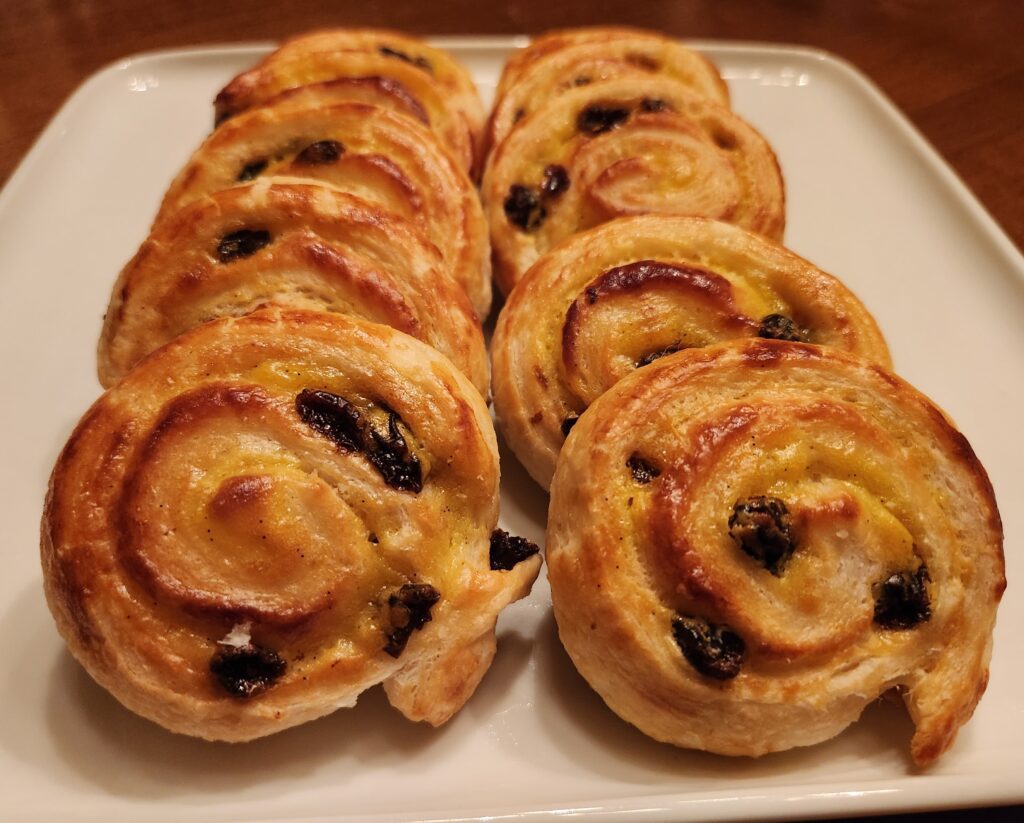 A white plate topped with lots of pastry.