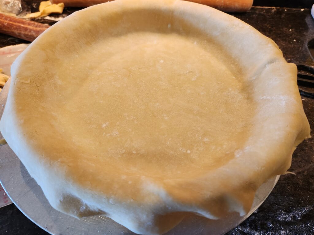 A pie crust sitting on top of a table.