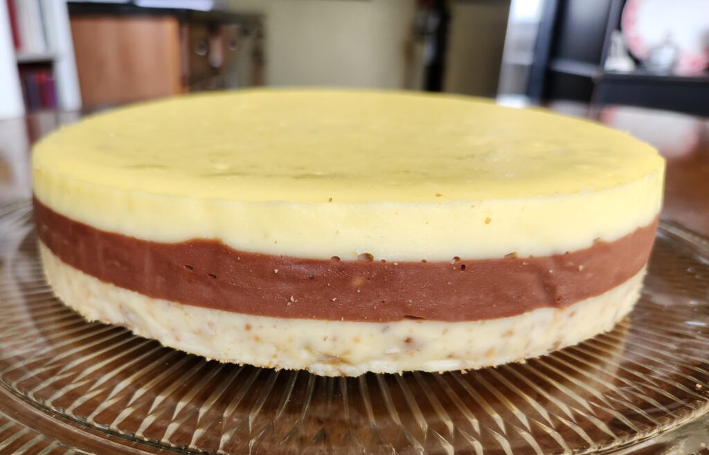 A cake sitting on top of a wooden board.