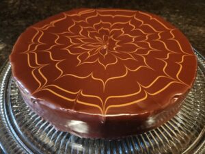 A chocolate cake decorated with a swirl pattern.