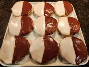 Donuts with chocolate and white icing on a plate.