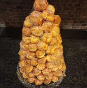 A stack of doughnuts on top of a counter.
