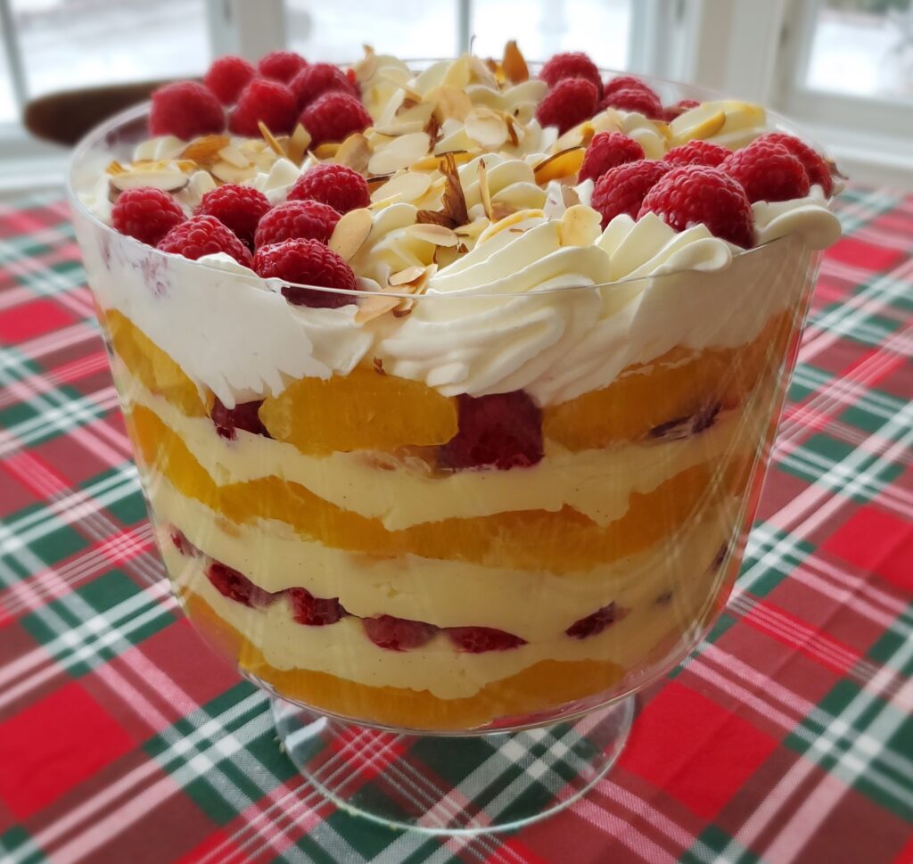 A trifle with raspberries and whipped cream.