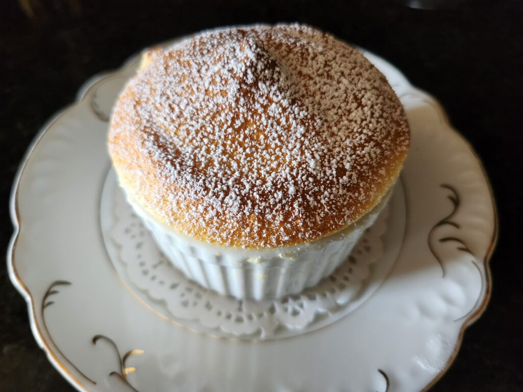 A small cake on top of a white plate.