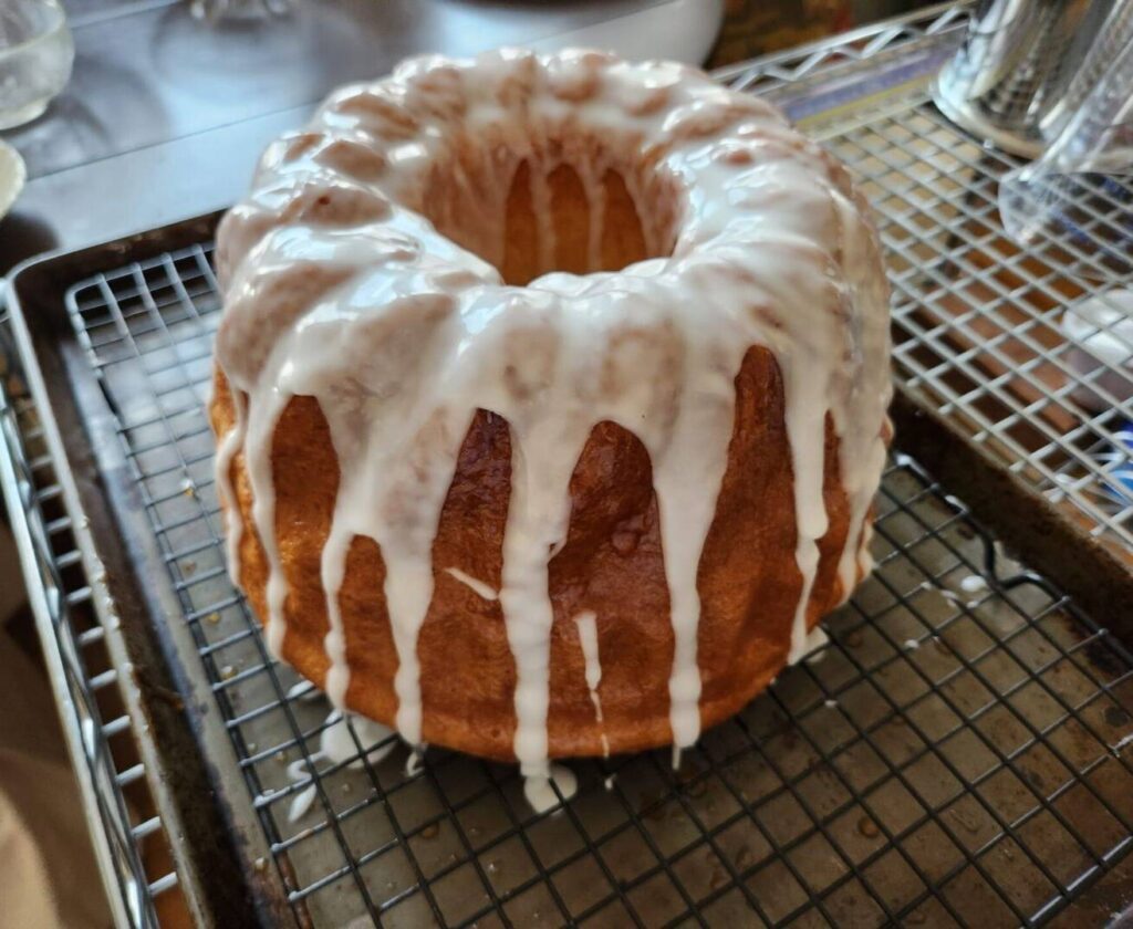 A bundt cake with white icing on top of it.