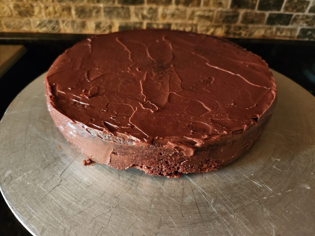 A chocolate cake sitting on top of a table.