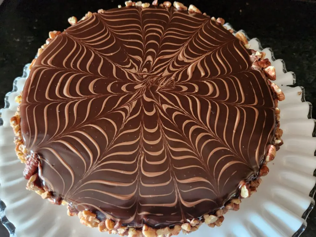 A chocolate cake with a decorative design on top.
