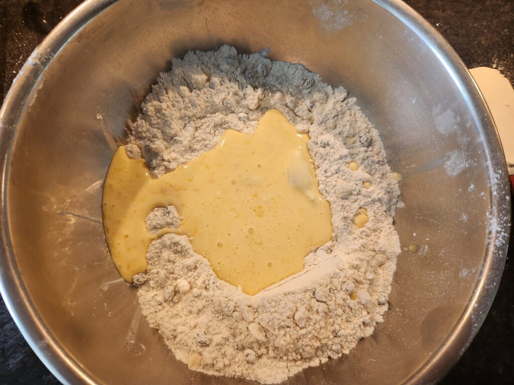 A bowl of food with some flour and butter